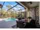 Outdoor patio with dining table and chairs overlooking the pool at 5431 Solterra Cir, Davenport, FL 33837