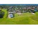 Aerial view of community featuring tennis courts, community center, pool, and playground at 290 Silver Maple Rd, Groveland, FL 34736