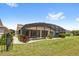 Sprawling fenced-in backyard featuring lush green grass and a screened in pool at 290 Silver Maple Rd, Groveland, FL 34736