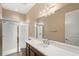 Bathroom featuring a glass enclosed shower and a single sink vanity with wood cabinets at 290 Silver Maple Rd, Groveland, FL 34736