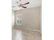Cozy bedroom with tile flooring, neutral walls, and a bright window at 290 Silver Maple Rd, Groveland, FL 34736