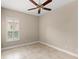 Neutral bedroom featuring tile flooring, ceiling fan and plantation shutters at 290 Silver Maple Rd, Groveland, FL 34736