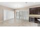 Dining area features a chandelier, tile floors, and plenty of natural light from sliding glass doors at 290 Silver Maple Rd, Groveland, FL 34736