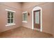 Inviting front porch featuring brick flooring, decorative windows, and a charming front door with glass detailing at 290 Silver Maple Rd, Groveland, FL 34736