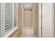 Hallway with a window that has white shutters and a neutral color pallet at 290 Silver Maple Rd, Groveland, FL 34736