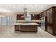 Lovely kitchen with island, dark cabinets, stainless steel appliances, recessed lighting, and a window above sink at 290 Silver Maple Rd, Groveland, FL 34736