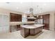 Modern kitchen with stainless steel appliances, a large island, granite countertops, and dark wood cabinets at 290 Silver Maple Rd, Groveland, FL 34736