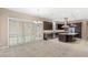 A well-lit kitchen featuring dark cabinetry, stainless steel appliances, a center island, and sliding glass doors at 290 Silver Maple Rd, Groveland, FL 34736