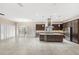 Spacious kitchen features a large center island, stainless steel appliances, dark cabinetry, and tile flooring at 290 Silver Maple Rd, Groveland, FL 34736