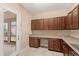 Bright laundry room featuring tile flooring, built-in desk, and direct access to the patio at 290 Silver Maple Rd, Groveland, FL 34736