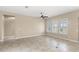 Bright, open living room with tile floors, neutral walls, recessed lighting, ceiling fan, and lots of natural light at 290 Silver Maple Rd, Groveland, FL 34736
