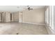 Spacious living area features tile floors, neutral walls, large windows, and a ceiling fan at 290 Silver Maple Rd, Groveland, FL 34736