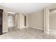 Open living room boasts neutral paint, tile floors, and an open floor plan at 290 Silver Maple Rd, Groveland, FL 34736