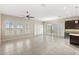 Open living room with tile floors, neutral walls, recessed lights, and large windows overlooking the backyard at 290 Silver Maple Rd, Groveland, FL 34736