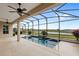 Enjoy an intimate screened-in pool with lake views, ceiling fans, and a relaxing atmosphere at 290 Silver Maple Rd, Groveland, FL 34736