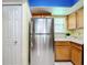 Stainless steel refrigerator in a well-lit kitchen with wood cabinets at 4037 W Maryland Pl, Casselberry, FL 32707