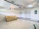 Finished garage features tile flooring, a couch, and ample storage at 2906 Woodruff Dr, Orlando, FL 32837
