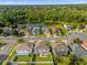 Aerial view of homes in a neighborhood with backyard fences surrounding a serene pond and lush greenery at 132 Spanish Bay Dr, Sanford, FL 32771