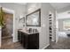 This neutral bathroom features a large vanity mirror, and views to a shower and bedroom at 132 Spanish Bay Dr, Sanford, FL 32771