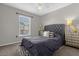 Cozy bedroom featuring a tufted headboard, stylish nightstands, and a patterned area rug at 132 Spanish Bay Dr, Sanford, FL 32771