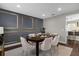 Formal dining room with designer wall decor and view into modern kitchen at 132 Spanish Bay Dr, Sanford, FL 32771