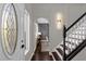 Inviting entryway featuring a decorative glass door and staircase with modern lighting at 132 Spanish Bay Dr, Sanford, FL 32771