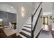 Elegant entryway with staircase, detailed wall trim, and arched doorway to the dining room at 132 Spanish Bay Dr, Sanford, FL 32771