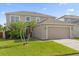 Inviting two-story home with lush landscaping and a spacious two-car garage at 132 Spanish Bay Dr, Sanford, FL 32771