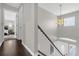 Hallway featuring hardwood floors and a stairway with white railings at 132 Spanish Bay Dr, Sanford, FL 32771