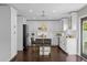 Bright kitchen with white cabinetry, stainless steel appliances, and dark wood-look floors at 132 Spanish Bay Dr, Sanford, FL 32771