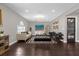 Bright living room featuring dark wood-look floors, modern furnishings, and stylish decor at 132 Spanish Bay Dr, Sanford, FL 32771