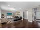 Stylish living room with dark floors, contemporary furniture, and view into the entry area at 132 Spanish Bay Dr, Sanford, FL 32771