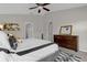 Spacious main bedroom with ceiling fan, large window and a dresser and mirror at 132 Spanish Bay Dr, Sanford, FL 32771