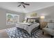 Spacious main bedroom features a ceiling fan, a large window, and stylish furniture at 132 Spanish Bay Dr, Sanford, FL 32771