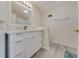 Modern bathroom with a white vanity, large mirror, and tile flooring at 2620 Osceola Bluff Ln, Geneva, FL 32732