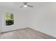 Well-lit bedroom featuring tile floors, a ceiling fan, and a window with a view to the outdoors at 2620 Osceola Bluff Ln, Geneva, FL 32732