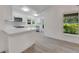 Modern, all-white kitchen with quartz countertops and stainless steel appliances at 2620 Osceola Bluff Ln, Geneva, FL 32732