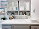 Modern bathroom with gray cabinets, a white countertop, and large mirrors at 100 E Oak Terrace Dr # G1, Leesburg, FL 34748