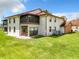 Rear view of the house showing a screened patio and a well-maintained lawn at 100 E Oak Terrace Dr # G1, Leesburg, FL 34748