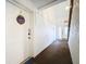 Clean hallway with white walls, carpet flooring, and a white door at 100 E Oak Terrace Dr # G1, Leesburg, FL 34748