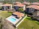 An aerial view of a community pool with chairs in a complex with several buildings at 913 Lotus Vista Dr # 101, Altamonte Springs, FL 32714