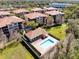 An aerial view of a community pool in a complex with several buildings and green spaces at 913 Lotus Vista Dr # 101, Altamonte Springs, FL 32714