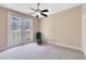 Cozy bedroom with ceiling fan and french doors leading to balcony overlooking the neighborhood at 913 Lotus Vista Dr # 101, Altamonte Springs, FL 32714