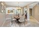 Elegant dining room with stylish chandelier, seating for six, and archway to the living room at 913 Lotus Vista Dr # 101, Altamonte Springs, FL 32714