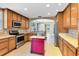 Functional kitchen featuring wooden cabinetry, stainless appliances, and center island for meal preparation at 913 Lotus Vista Dr # 101, Altamonte Springs, FL 32714