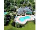 Aerial view showing resort-style pool, clubhouse, and lush landscaping at 113 Rogues Retreat, Davenport, FL 33897