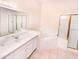 Double vanity, bathtub, and walk-in shower at 113 Rogues Retreat, Davenport, FL 33897