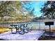 Relaxing picnic area with table and grill by the lake at 113 Rogues Retreat, Davenport, FL 33897