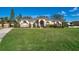 Single-story home exterior with stone accents and manicured lawn at 13707 Calle De Ora Ct, Clermont, FL 34711