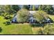Aerial view of townhome featuring a well-maintained lawn, mature trees, and classic facade at 2722 Graduate Ct, Orlando, FL 32826